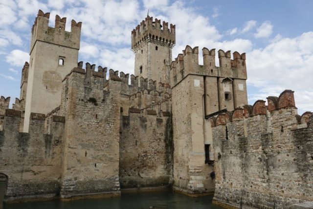 Scaliger castle Sirmione medieval town Garda lake, port fortification of the middle ages. It presents the typical Ghibelline swallowtail merlons.Day tour wiht Sightseeing in Italy